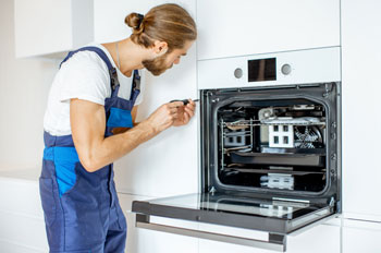 Technician fixes the oven